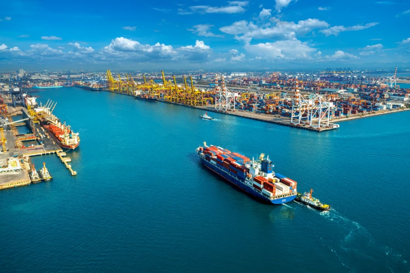International shipping port with container ships and cargo cranes for air freight and international courier services Melbourne