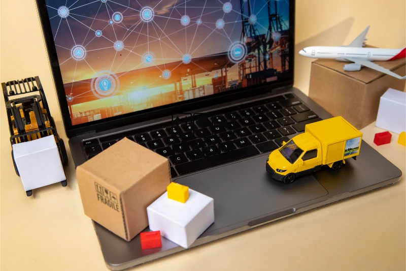 Melbourne courier service delivery trucks and packages on laptop showing logistics network for business parcel delivery